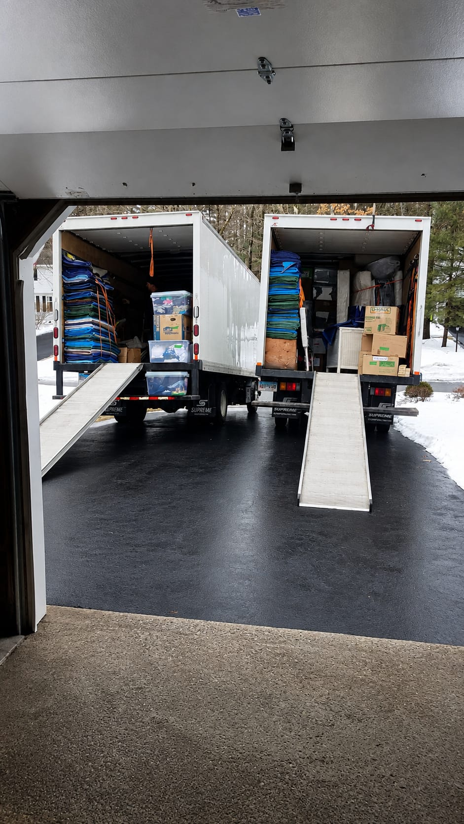 Johns Delivery Service moving trucks with ramps ready for a move